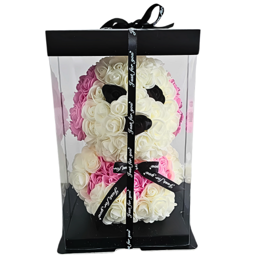 Elegant floral puppy figurine made with white, pink, and black roses in a transparent gift box tied with satin ribbon, a unique and sweet gift for children, celebrations, or special occasions. My Playful Forever rose puppy with handcrafted floral details, packaged in a clear box with ribbon, ready for gifting as a forever friend for milestones or just because moments. My Playful Forever - Snug Box