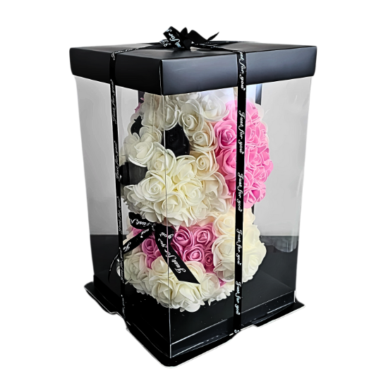 Handcrafted white rose puppy with soft pink rose ears and black rose eyes, beautifully packaged in a clear display box with satin ribbon, perfect gift for birthdays, new babies, and playful keepsakes. ideal for gifting as a charming and lasting symbol of affection and innocence. My Playful Forever - Snug Box